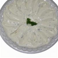 Tzatziki · Our own mixture of yogurt, cucumber, and spices. Served as a dip with two pita breads.