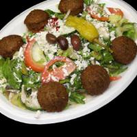 Falafel Greek Salad · Vegetarian. Classic Greek salad served with falafel, includes pita bread and sauce.