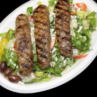 Ground Beef Salad · Classic greek salad served with 3 skewers of ground beef, includes pita bread and sauce.