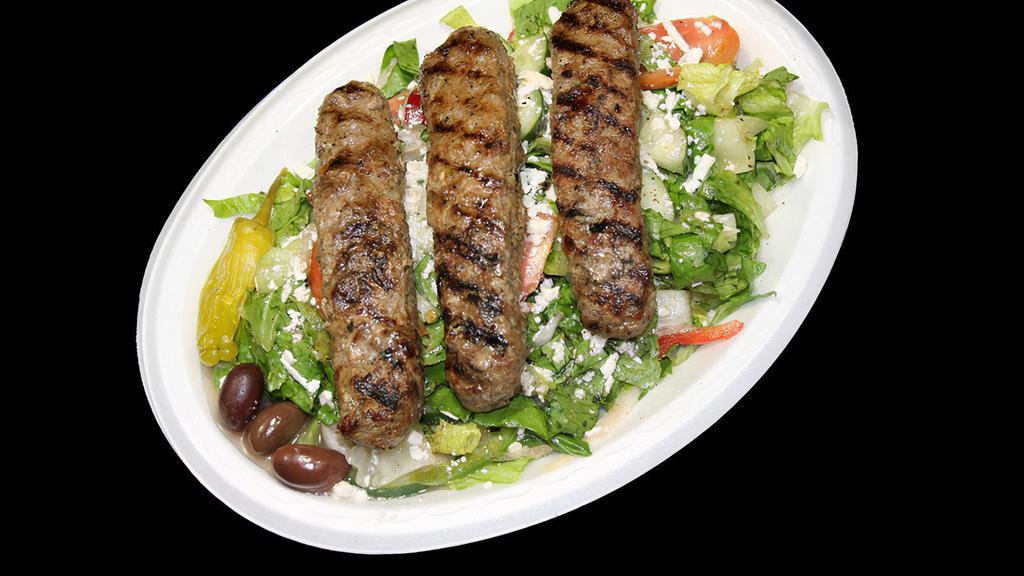 Ground Beef Salad · Classic greek salad served with 3 skewers of ground beef, includes pita bread and sauce.