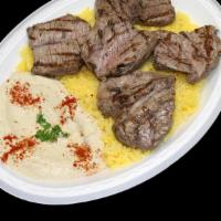 Steak Kabob Plate · A kabob of tender pieces of tri-tip sirloin marinated and flame broiled, served with our own...