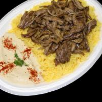 Steak Shawarma Plate · Marinated beef, broiled on a vertical skewer, thinly sliced, and served with our own garlic ...