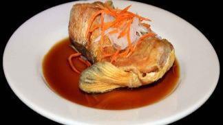 Salmon Kama · Fried salmon jaw with white onion, carrots and special sauce.