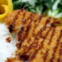 Katsu Curry Rice · Japanese curry over rice, breaded pork cutlet, pickles, bok choy.