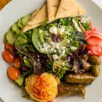 Mediterranean Salad · Mixed greens, hummus, dolmas, cucumber, tomato, feta, olives, herb vinaigrette, house-made n...