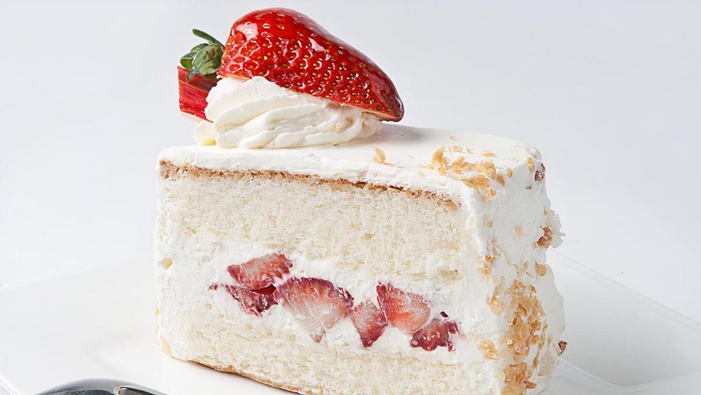 Strawberry Shortcake Slice · Delicate white cake filled and iced with fresh whipped cream and layered with sliced California strawberries.