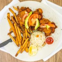 Milanesa De Pollo · Breaded chicken breast fried and served with French fries and rice. Topped with tomato and a...