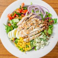 California Cobb Salad · Grilled chicken, corn, tomatoes, bleu cheese crumbles, red onions, egg wedges and bacon bits...
