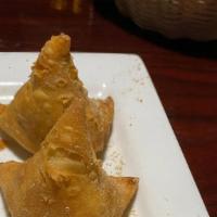 Classic Samosa (1 Pcs) · Vegetarian. Triangle shaped deep-fried dumplings filled with spiced and mashed potatoes and ...