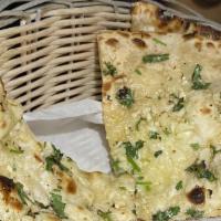 Garlic Naan · Vegetarian. House made pulled and leavened dough loaded with fine chopped garlic and baked t...