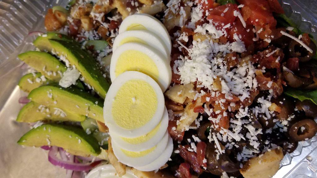 Cobb Salad · Grilled chicken, tomatoes, avocado, bacon, red onions, black olives, cucumbers, feta and chopped egg on a bed of romaine with your choice of bleu cheese or buttermilk ranch dressing.