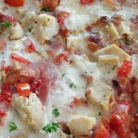 Chicken Bacon Ranch Pizza · Garlic chicken, bacon crumbles, Canadian bacon and cooked tomatoes on our buttermilk ranch b...
