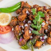 Chicken Pepper Fry · Battered fried chicken tossed with onions and spicy sauce.