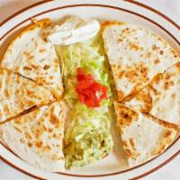 Quesadilla · chicken or beef, topped with sour cream, and guacamole.