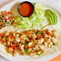 Fish Tacos · breaded fish, served with pico de gallo, lettuce, tomatoes, and sliced avocados.