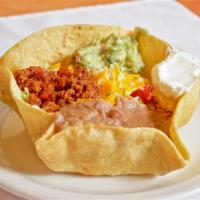 Taco Salad · crunchy tortilla bowl filled with choice of chicken or beef, beans, tomatoes, guacamole, sou...