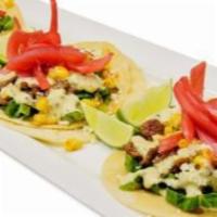 Asada Street Tacos · Soft corn tortillas, grilled carne asada, cilantro, shedded lettuce, topped with roasted cor...