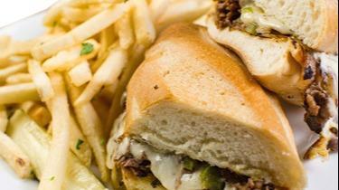 South Philly Cheese Steak · Shaved sirloin grilled with onions, peppers, and smothered with provolone cheese, served on fresh hoagie roll
