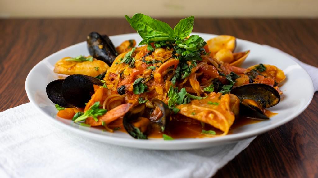 Seafood Cioppino With Pasta Capellini · Sautéed mussels, clams, scallops, shrimp, fish, crusted peppers, garlic, tomatoes and white wine.
