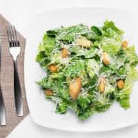 Caesar Salad · Romaine lettuce and croutons tossed in authentic caesar dressing topped with aged Parmigiano...