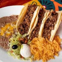 Tacos De Carne Asada Or Grilled Chicken · Three soft shell tacos with grilled chopped top sirloin OR grilled chicken, served with gril...