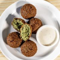Falafel · Dried garbanzo and fava beans ground and mixed with onions, parsley and deep fried.
