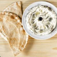 Garlic Dip · a creamy mix of garlic, lemon & olive oil comes with two pita.