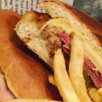 Cubano (Media Noche) · Ham, pork, swiss cheese, pickles, mustard, on a Cubano bread.