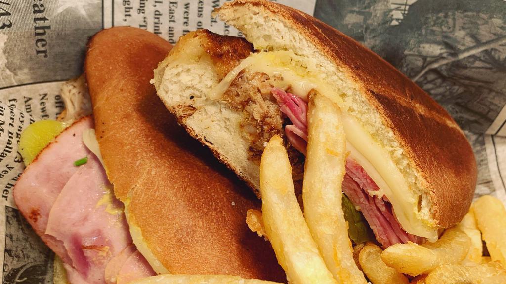 Cubano (Media Noche) · Ham, pork, swiss cheese, pickles, mustard, on a Cubano bread.