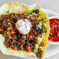 Taco Salad · Crisp taco shell filled with lettuce, seasoned beef, cheese, tomatoes, olives and onions. So...