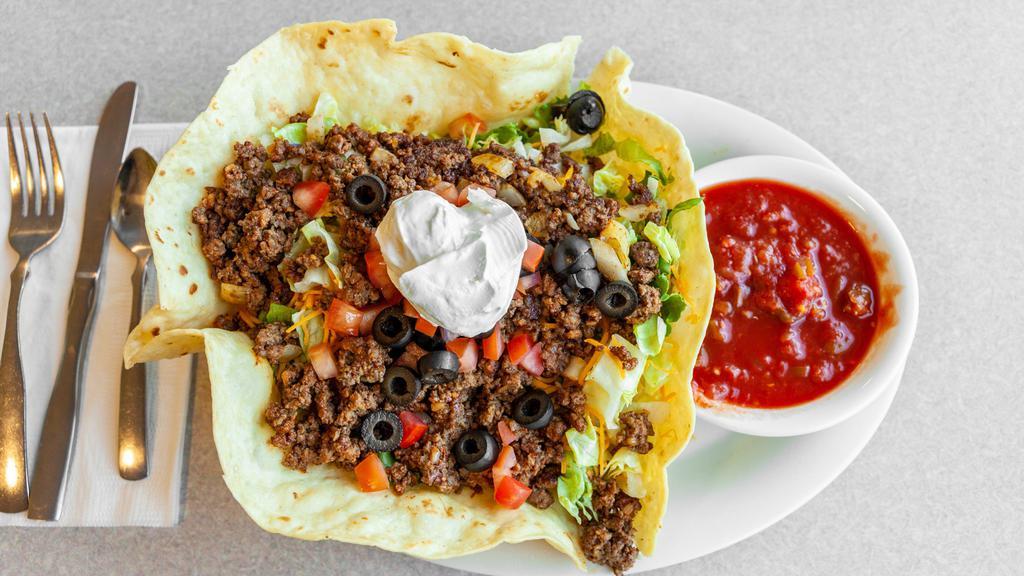 Taco Salad · Crisp taco shell filled with lettuce, seasoned beef, cheese, tomatoes, olives and onions. Sour cream and salsa. GF with no shell.
