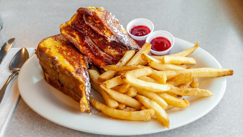 Monte Cristo Sandwich · Turkey, ham, Swiss and Cheddar cheese layered between egg bread. Dipped in egg batter and grilled. Dusted in powdered sugar- yum.