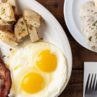 Country Breakfast · Two strips of bacon, two sausage links served with country potatoes, two eggs any style, and...