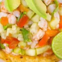 Ceviche Tostada · Cured Shrimp, Lime, Cucumber, Tomato and Onion. Topped with Avocado on Homemade Tostada.