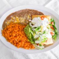 Asada (Steak) Chimichanga Plate · Fried flour tortilla, with beans, meat, cheese inside, rice and beans on the side, lettuce, ...