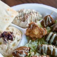 Mazza Plater · A variety platter of hummus, Baba ghanoush, dolma, falafel and Zahra.