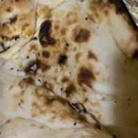 Tandoori Naan · Unleavened bread cooked in our own tandoori oven. Baked fresh to order.