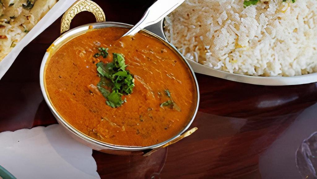 Chicken Makhani · Boneless chicken cooked with onions, garlic, ginger, tomatoes, butter, cream and curry spices. Served with rice.