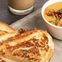 Tomato Soup (Roasted Garlic) & Grilled Cheese · Roasted garlic tomato soup and a grilled cheese panini.
