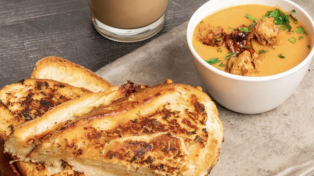 Tomato Soup (Roasted Garlic) & Grilled Cheese · Roasted garlic tomato soup and a grilled cheese panini.