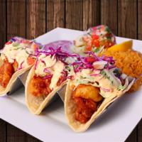 Tacos De Camarón · Three soft tacos with battered and fried shrimps. Topped with red and white cabbage, a cream...