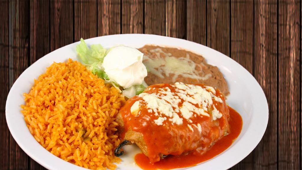 Poblano Chile Relleno · Roasted pasilla pepper and filled with Mexican cheese. Cover with tomato sauce. Garnished with sour cream. Sprinkled with queso fresco.