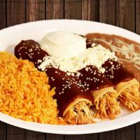 (2) Enchiladas De Mole · Covered with mole sauce. Topped with sesame seeds, Mexican cheese and sour cream. Spicy, not...