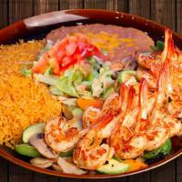 Camarones A La Plancha · Grilled jumbo prawns (in shell) marinated in garlic and butter over a bed of sautéed white o...