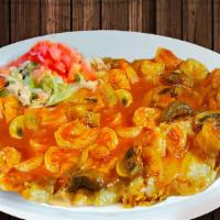 Arroz Con Camarones · 18 shrimp cooked in a light sauce with mushrooms and onions. Placed on a bed of rice and mel...