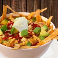 Sopa De Tortilla · Our own recipe includes shredded chicken, tortilla chips and spices in a delicious chicken b...
