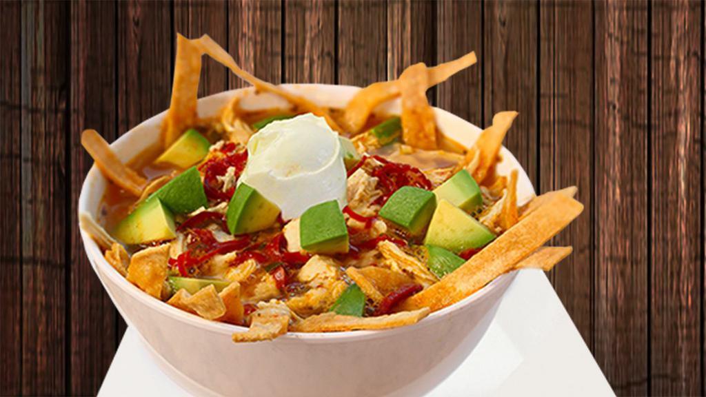 Sopa De Tortilla · Our own recipe includes shredded chicken, tortilla chips and spices in a delicious chicken broth. Topped with diced avocado and sour cream. No rice or beans included.