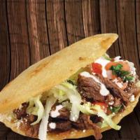 Gordita · A thick handmade tortilla filled with refried beans, your choice of meat, onions, cilantro, ...