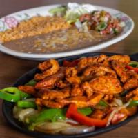 Chicken Fajitas · Chicken, grilled with fresh bell peppers, onions, and spices. Served with refried beans, ric...