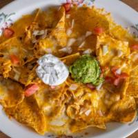 Super Nachos · Chips, beans and Cheddar cheese melted with your choice of chicken or ground beef. Topped wi...